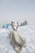 Young woman reading in snow