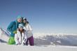 Couple and daughter in ski wear, looking away