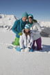 Couple and daughter in ski wear, smiling at camera