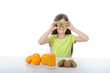 Little girl holding kiwi slices in front of his eyes Little girl holding kiwi slices in front of his eyes