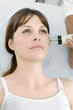 Photo: young caucasian woman receiving electrostimulation lifting young caucasian woman receiving electrostimulation lifting