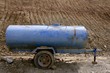 Blue water container trailer to wet soil in roads contruction