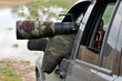 Bird photographer taking photos with camouflaged telephoto lens. Bird photographer taking photos with camouflaged telephoto lens.