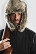 hunter winter fur hat man portrait holding gun