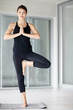 Young fitness female standing a yogatic stance