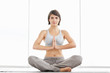 Fitness woman practicing yoga in the lotus position
