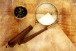 Compass and magnifier  on old textured paper