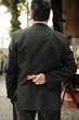 liar: businessman with fingers crossed behind his back