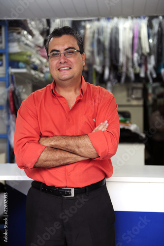 Photo: happy owner of a dry cleaning business happy owner of a dry cleaning business