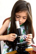 Girl looks through microscope