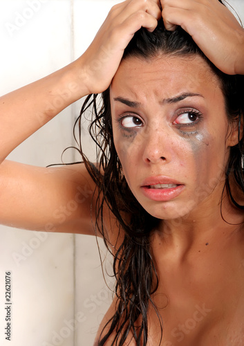 Photo: Young brunette woman emotional and sad in the bathroom Young brunette woman emotional and sad in the bathroom