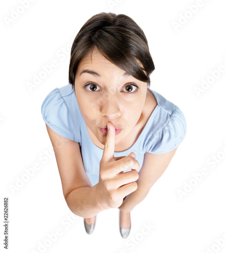Photo: Top view of a female gesturing silence isolated on white Top view of a female gesturing silence isolated on white