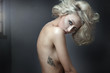 Beautiful nude blonde beauty with tatoo