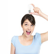 Young excited female holding a light bulb against white