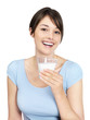 Smiling casual female drinking milk against white