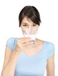 Young female drinking a glass of fresh milk against white