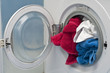 Open Washing machine with white, red and blue cloths Open Washing machine with white, red and blue cloths