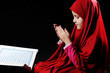 Muslim girl with Holy Book Koran