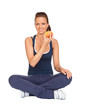 Gymnastics girl with an apple sitting with cross-legs