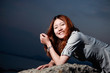 Beautiful young woman on the beach at sunset .