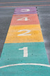 A colourful hopscotch game painted on a playground A colourful hopscotch game painted on a playground