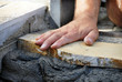 Photo: Worker hand on flagstone Worker hand on flagstone