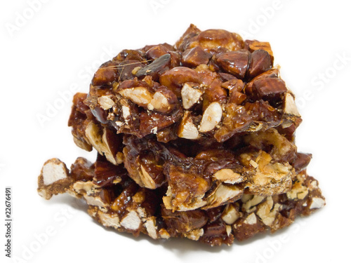 Photo: Sugared almond nougat isolated on white. Sugared almond nougat isolated on white.