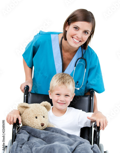 Photo: Nice female doctor carrying adorable little boy in the wheelchai Nice female doctor carrying adorable little boy in the wheelchai