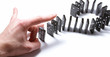 Dominoe pieces with a human hand on a white background