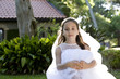 Photo: Beautiful young girl in white dress sitting on bench Beautiful young girl in white dress sitting on bench