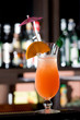 Fresh iced cocktail garnished orange and umbrella.