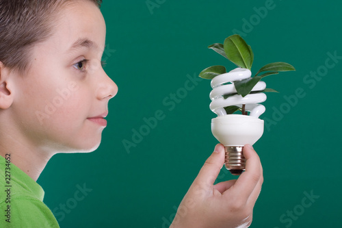Photo: Kid with energy saving bulb Kid with energy saving bulb