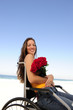 woman in wheelchair with red roses