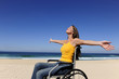 woman in wheelchair enjoying summer vacation on the  beach