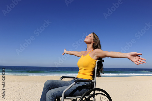 Photo: woman in wheelchair enjoying summer vacation on the beach woman in wheelchair enjoying summer vacation on the beach