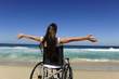 woman in wheelchair enjoying summer vacation on the  beach