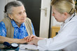 An elderly women being examined by a doctor