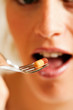 Woman eating nutritional supplements