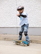 child skateboarding with helmet, knee pads & elbow protection