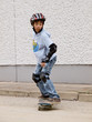 child skateboarding with helmet, knee pads & elbow protection