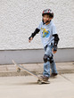 child skateboarding with helmet, knee pads & elbow protection