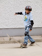 child skateboarding with helmet, knee pads & elbow protection