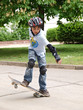 child skateboarding with helmet, knee pads & elbow protection