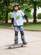 child skateboarding with helmet, knee pads & elbow protection