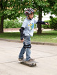 child skateboarding with helmet, knee pads & elbow protection
