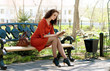 lady reads on bench in park
