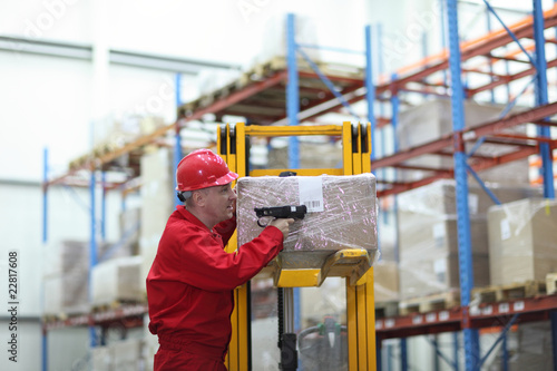 Foto: worker with bar code reader working in warehouse worker with bar code reader working in warehouse