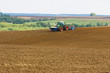 agrarian machine in a ploughed field agrarian machine in a ploughed field