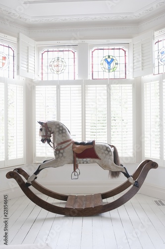 Photo: Antique rocking horse in bay window with stained glass, London Antique rocking horse in bay window with stained glass, London