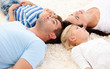 Happy family lying on the floor together